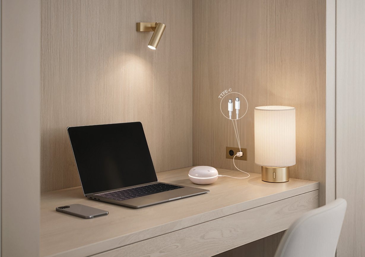 Clervo IAQ on a minimal wooden desk, plugged in via Type-C next to a laptop and bedside lamp